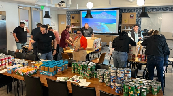 Symmetry office participating in a food drive for United Food Bank